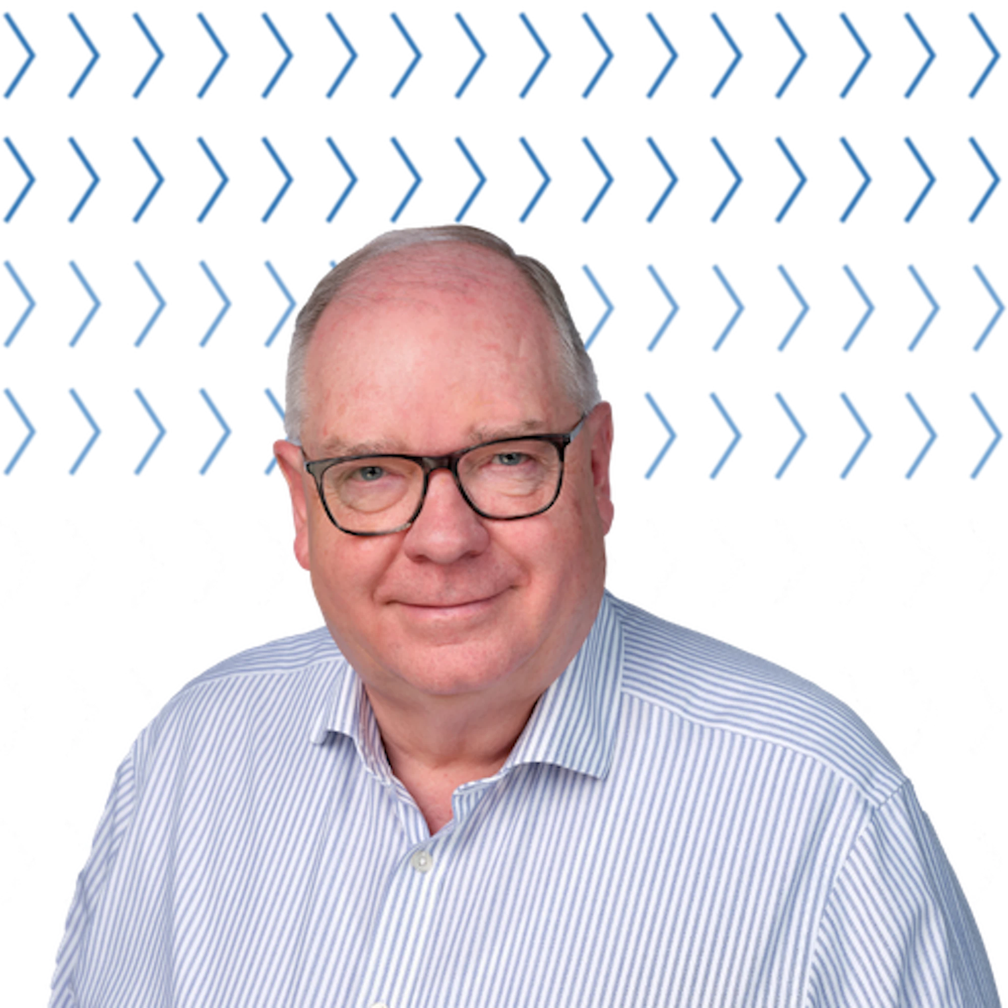 graham reiner wearing glasses and blue and white striped shirt.